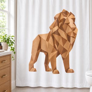 May include: A white shower curtain featuring a large, centred geometric lion illustration composed of various shades of brown and tan triangular shapes. The lion is depicted in a standing profile position with a stylised, angular mane and body.