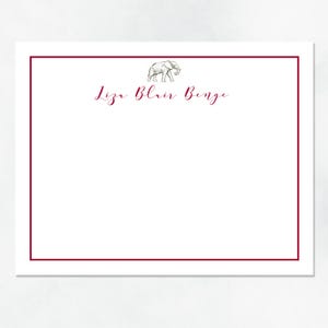 May include: A white card with a burgundy border. The card has a simple line drawing of an elephant in the top center. The text "Liza Blair Benge" is written in burgundy cursive below the elephant.