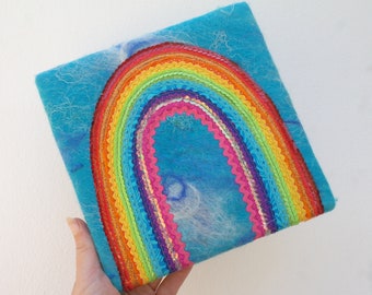 Rainbow of Hope - A Textile Rainbow Painting. A Happy Applique Rainbow on handmade sky blue felt. Funky rainbow of trims, sequins, ric rac.