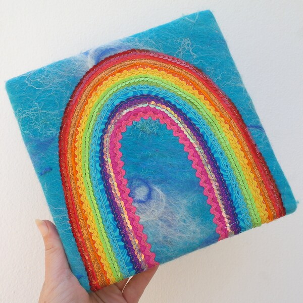 Rainbow of Hope - A Textile Rainbow Painting. A Happy Applique Rainbow on handmade sky blue felt. Funky rainbow of trims, sequins, ric rac.