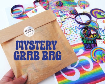 Mystery Grab Bag - These Lucky Dip Rainbow Surprise Gift Bags contain colourful stickers, enamel pin, badges, magnet, wristband & a card.