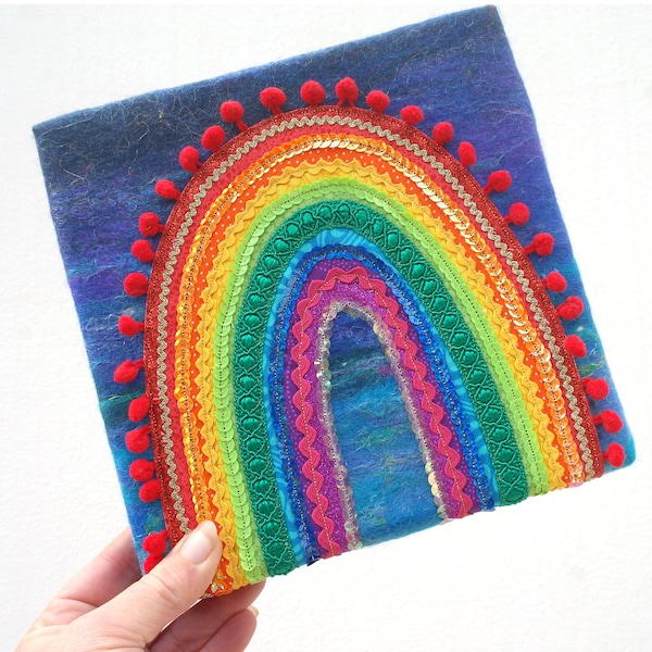 Happy Rainbow of Hope -  A Happy Applique Rainbow on handmade blue felt. Textile Rainbow Painting. Funky rainbow of trims, sequins, ric rac.