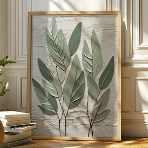May include: A framed artwork featuring a botanical design of green leaves on a textured white background. The artwork is displayed in a room with a window, a potted plant, and a stack of books. The frame is made of wood.