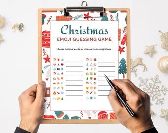 May include: A clipboard with a Christmas Emoji Guessing Game. The game sheet has a festive border with holiday-themed illustrations. A hand holds a pen, ready to write answers to emoji clues. Decorative ornaments surround the clipboard.