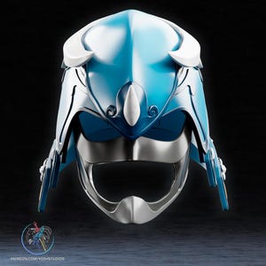 May include: A futuristic helmet with a glossy, light blue and silver design. The helmet features white accents and intricate detailing, including curved shapes and a visor. The overall aesthetic suggests a sci-fi or cosplay theme.