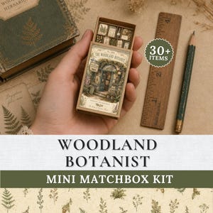 May include: A Woodland Botanist mini matchbox kit featuring a rectangular box with a vintage-style illustration of a shop front, containing small paper items. A wooden ruler marked in inches and a pencil are positioned next to the box.