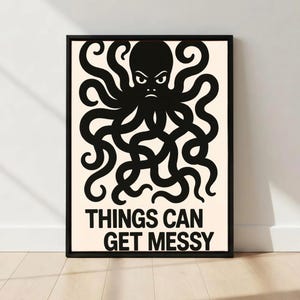 May include: Black framed art print featuring a black octopus illustration with an angry expression. The text "THINGS CAN GET MESSY" is printed in black below the octopus on a cream background. The art is displayed on a white wall.