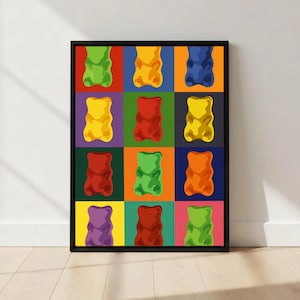 Peut inclure: Une impression encadrée présentant une grille d'illustrations de bonbons gélifiés colorés. Chaque ours est d'une couleur différente, notamment vert, jaune, rouge et orange, sur un fond vibrant. L'œuvre est exposée sur un mur blanc.