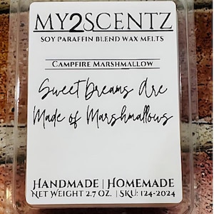 May include: A white wax melt container with the text "MY2SCENTZ SOY PARAFFIN BLEND WAX MELTS CAMPFIRE MARSHMALLOW Sweet Dreams are Made of Marshmallows HANDMADE | HOMEMADE NET WEIGHT 2.7 OZ. | SKU: 124-2024"