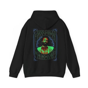 May include: Black hoodie with a graphic print of a man's face with the text "Childish Gambino" in a psychedelic font.