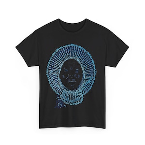 May include: Black t-shirt with a blue and white graphic of a face surrounded by a circle of text.