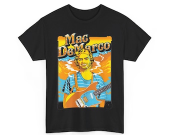 May include: Black t-shirt with a graphic of Mac DeMarco holding a guitar. The graphic is in a retro style with orange, yellow, and blue colors. The text "Mac DeMarco" is in a yellow font.