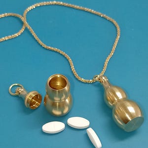 Pastillero o caja secreta, botellito montado como collar colgante, pastillero portátil, en acero bañado en oro