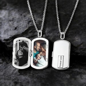 May include: Silver-colored locket necklace with a rectangular pendant. The locket opens to reveal two family photos. The closed pendant has the words "Forever Love" engraved on it. The necklace chain is a linked design.