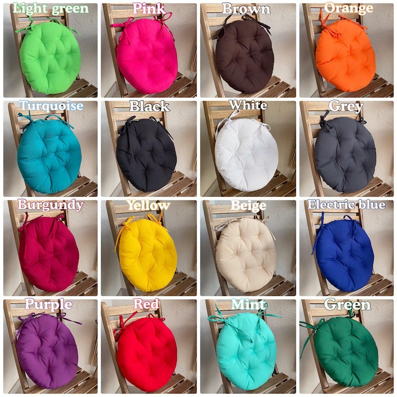 Puede incluir: Una colecci&oacute;n de diecis&eacute;is cojines redondos para silla en varios colores s&oacute;lidos, incluyendo verde claro, rosa, marr&oacute;n, naranja, turquesa, negro, blanco, gris, burdeos, amarillo, beige, azul el&eacute;ctrico, morado, rojo, menta y verde oscuro, con lazos.