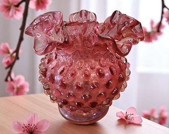 Fenton vase cranberry hobnail with a small ribbon top.