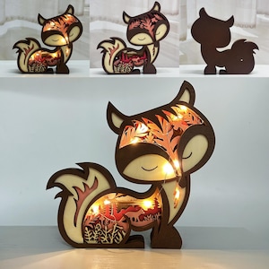May include: A wooden fox figurine with intricate cutouts and LED lights. The fox is standing on all fours with its tail curled around its body. The lights illuminate the cutouts, creating a warm glow.