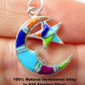 May include: A sterling silver pendant featuring a crescent moon and star design, inlaid with colorful gemstones. The pendant has a loop for a chain and is inscribed with "100% Natural Gemstones Inlay In 925 Sterling Silver Handmade In USA."