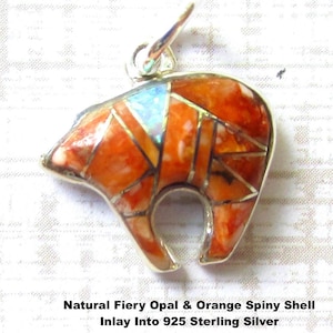 May include: A bear-shaped pendant crafted from 925 sterling silver featuring an inlay of natural fiery opal and orange spiny shell. The pendant includes a silver bail at the top. Text on the image reads: Natural Fiery Opal & Orange Spiny Shell Inlay Into 925 Sterling Silver Handmade In USA Close Up Photo.