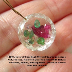 May include: A round, faceted clear rock crystal quartz gemstone, hollowed out and filled with loose natural emeralds, rubies, and pink sapphires. The piece is drilled at the top. Text reads: 100% Natural Clear Rock CRystal Quartz Gemstone Cut, Faceted, Hallowed Out Then Filled With Natural Emeralds, Rubies, PinkSapphires. Drilled As Shown Wire Not Included.