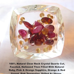 May include: A square, faceted clear rock crystal quartz pendant, hollowed and filled with loose natural ruby, pink and orange sapphire, orange and red garnet, and pink tourmaline gemstones. The text reads: 100% Natural Clear Rock Crystal Quartz Cut, Faceted, Hallowed Then Filled With Natural Ruby, Pink & Orange Sapphire, Orange & Red Garnet, Pink Tourmaline. Drilled As Shown.