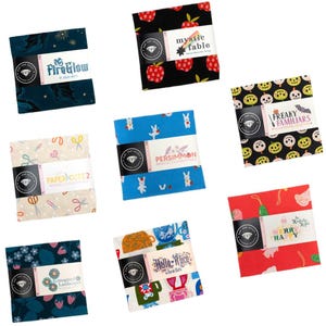 May include: A collection of eight square fabric charm packs from Ruby Star Society, each featuring distinct patterns and labels including FireGlow, Mystic Fable, Freaky Familiars, Paper Cuts 2, Persimmon, Reimagined Landscapes, Hello Alice, and Merry Happy.