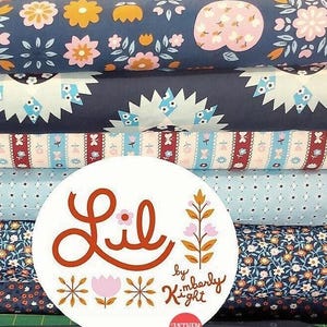 May include: A stack of five fabric panels with different floral and geometric patterns in shades of blue, pink, white, and brown. The panels are labeled "Lil' by Kimberly Kight".