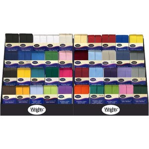 May include: A display of Wrights double fold bias tape in various colors, including black, white, blue, yellow, red, and green. The display is organized in rows and columns, with each color neatly stacked.