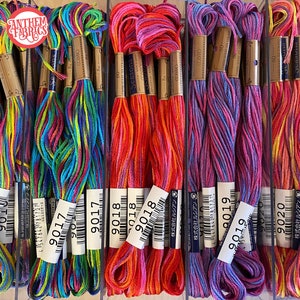 May include: A close-up of ten spools of colorful embroidery floss. The floss is arranged in rows, with each row containing a different color combination. The spools are labeled with the numbers 9016, 9017, 9018, 9019, and 9020.