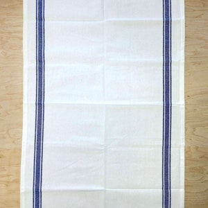 May include: White kitchen towel with two blue stripes along the sides.