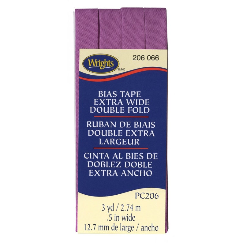 May include: Purple bias tape with the text "Wrights" and "206 066" on the label. The label also says "Bias Tape Extra Wide Double Fold", "Ruban de Biais Double Extra Largeur", and "Cinta al Bies de Doblez Doble Extra Ancho". The label also says "PC206", "3 yd / 2.74 m", ".5 in wide", and "12.7 mm de large / ancho".