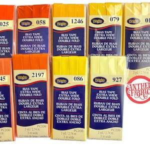 May include: Assortment of 10 rolls of extra wide double fold bias tape in orange and yellow colors. Each roll is labeled with the brand name "Wrights" and a product number. The tape is 5 inches wide and 3 yards long.