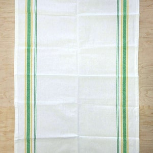 May include: White kitchen towel with green and yellow stripes along the sides.
