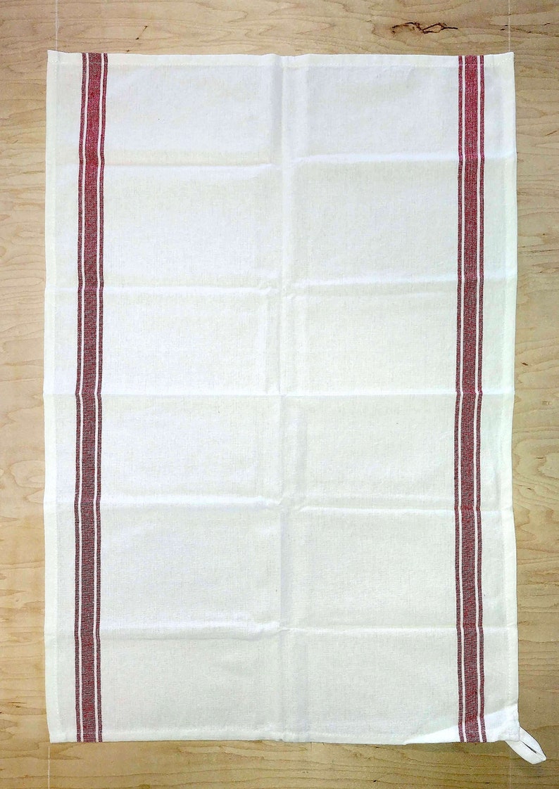 May include: White kitchen towel with two red stripes along the sides.