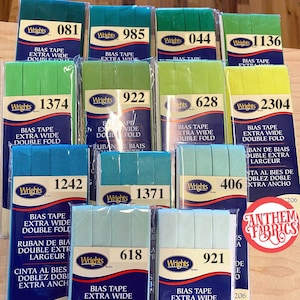 May include: A collection of 10 packages of bias tape in various colors, including green, blue, and yellow. Each package features the Wrights brand name and the text "Bias Tape Extra Wide Double Fold".