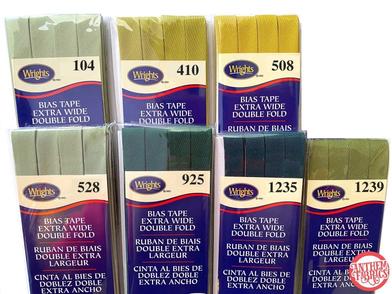 May include: Eight packages of Wrights bias tape in various shades of green. Each package has a label with the Wrights logo and the product name "Bias Tape Extra Wide Double Fold". The labels also include the product number, such as "104", "410", "508", "528", "925", "1235", and "1239".