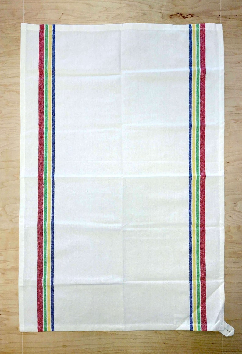 May include: White kitchen towel with red, green, yellow, and blue stripes along the sides.