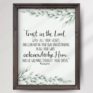 May include: A framed print with a white background and green watercolor leaves. The print features a bible verse from Proverbs 3:5-6 that reads "Trust in the Lord with all your heart, and lean not on your own understanding. In all your ways acknowledge Him, and He will make straight your paths."
