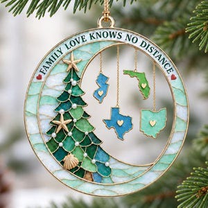 May include: A circular gold-toned ornament featuring a stained-glass style Christmas tree with starfish and seashell accents. The text "FAMILY LOVE KNOWS NO DISTANCE" is inscribed along the top. Four state-shaped charms hang inside the ring.