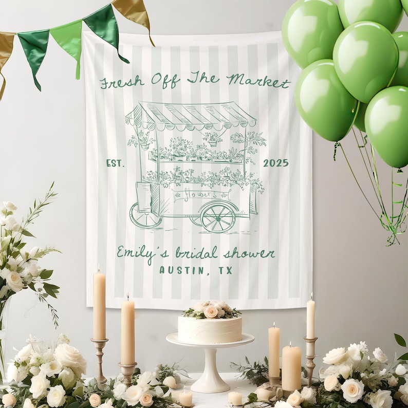 May include: A white and green striped banner with the text "Fresh Off The Market" and a drawing of a flower cart. The banner is for Emily's bridal shower in Austin, TX. Green balloons and candles are also present.