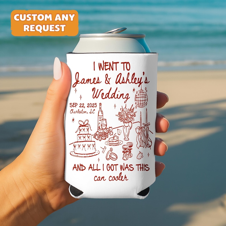 May include: White can cooler with a red illustration and text. The text reads "I went to James & Ashley's Wedding" with the date "SEP 22, 2025" and "Charleston, SC". The bottom text says "AND ALL I GOT WAS THIS can cooler".