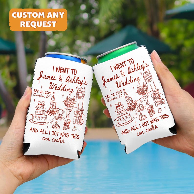 May include: Two white can coolers with a wedding theme. The text reads "I went to James & Ashley's Wedding" with the date "SEP 22, 2025". The phrase "AND ALL I GOT WAS THIS can cooler" is also printed on the coolers. The top left corner has a text that says "CUSTOM ANY REQUEST".