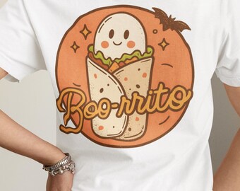 May include: White t-shirt with a Halloween-themed graphic. The design features a cartoon ghost inside a burrito, with the text "Boo-rrito" in a playful font. The design is set against an orange circle with a bat and small squares.