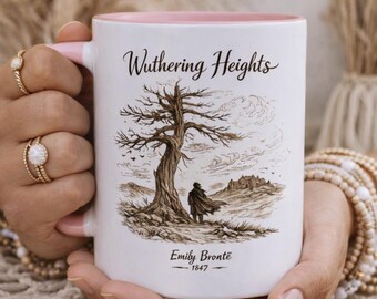 May include: White ceramic mug with a pink interior and handle. The mug features a sepia-toned illustration of a tree, a figure, and a castle, with the words "Wuthering Heights" and "Emily Brontë - 1847" printed on it.