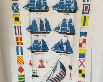 May include: A vintage tea towel with a nautical theme. It features illustrations of different types of sailing ships, including a ship, bark, barkentine, brig, brigantine, and schooner. The towel also includes a variety of nautical flags and the text "St. Thomas, V.I."