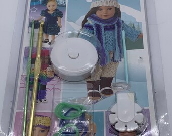 May include: A crochet kit for 18-inch dolls, featuring a colorful instruction booklet, yarn, crochet hooks, and a stitch marker. The kit includes instructions for making five different outfits.