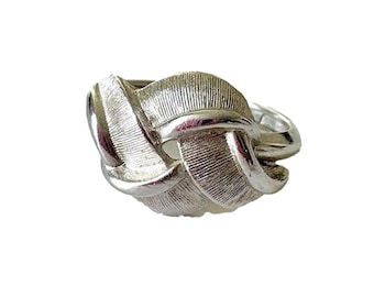 May include: A silver ring with a unique design featuring interwoven leaf-like shapes.