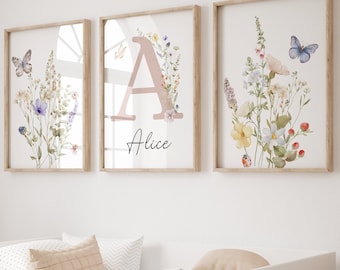 May include: Three framed prints with watercolor floral designs and butterflies. The center print features the letter "A" with the name "Alice" written below it.