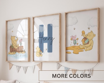 May include: Three Winnie the Pooh themed nursery prints with a light wood frame. The prints feature Winnie the Pooh and Piglet in different scenes. One print features the letter H and the name Henry.