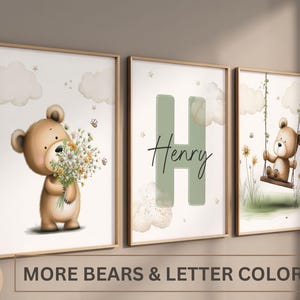 May include: Three framed nursery art prints with teddy bear illustrations. One bear holds flowers, another has the letter "H" and the name "Henry", and the third is on a swing. The text "MORE BEARS & LETTER COLORS" is at the bottom.